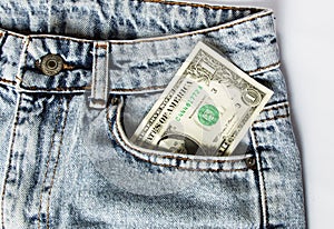 A dollar bill sticking out of a pocket of blue jeans, a credit card, and a wallet. Poverty and unemployment.