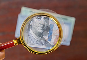 Dollar bill under a magnifying glass