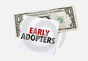 1 dollar bill and white notepad sheet on the white background. Text early adopters photo