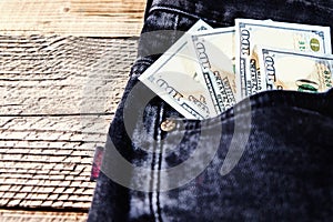 Dollar bills in the back pocket of jeans