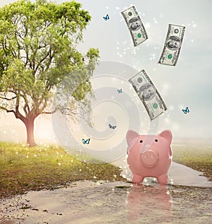 Dollar bills falling in or flying out of a piggy bank in a magical landscape