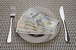 Dollar Bills on a plate with fork and knife