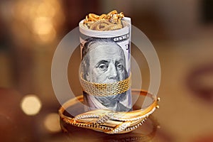 Dollar bills rolls money with gold jewelry