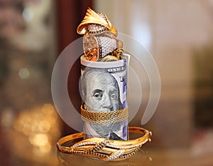 Dollar bills rolls money with gold jewelry