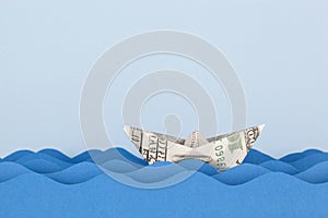 Dollar boat swimming on paper waves