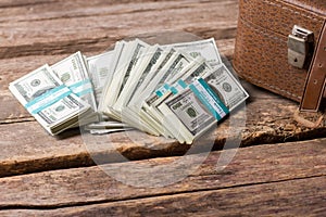 Dollar bundles and brown case.