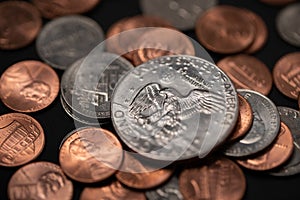 Dollar coins, One Dollar Eisenhower Dollar. Depicted Eagle landing on the moon. Pennies and Dimes surrounding Large Coin