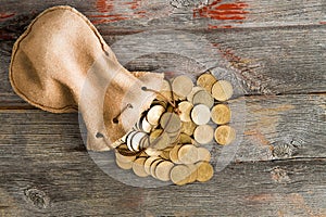 Dollar coins spilling out of a drawstring pouch