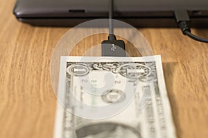 Dollar is connected to the computer by a wire