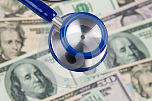 Dollar currency notes and stethoscope