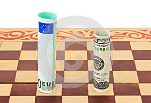 Dollar and euro on chess board