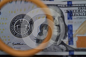 The dollar increases through a magnifying glass, check for falseness