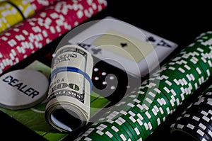 A 100 dollar kupurs is on the blackjack table next to poker chips and a dealer's chip