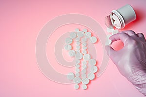 Dollar mark made by white pills spilling out of white bottle on pink background and the doctor holds a white pill. Medicine