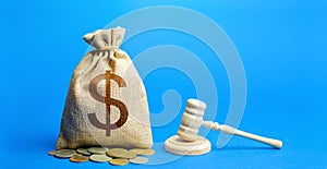 Dollar money bag and judge`s gavel. Litigation, dispute resolution, conflict of interest settlement. Awarding moral financial