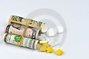 Dollar rolled up with pills flowing out isolated on white background, high costs of expensive medication concept. Copy space -