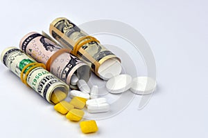 Dollar rolled up with pills flowing out isolated on white background, high costs of expensive medication concept. Copy space -