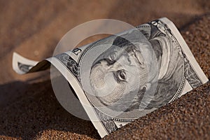 Dollar in the sand