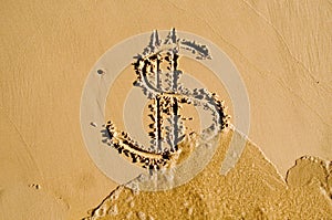 Dollar sign drawn in the sand