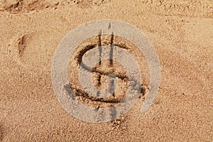 Dollar sign on sand