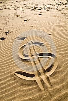 Dollar sign in the sand