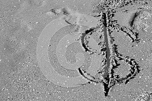 Dollar symbol drawn on the sand