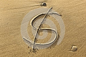 Dollar symbol drawn in the sand