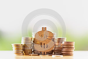 Dollar symbol and stack of coins in concept of savings and money growing or energy save.
