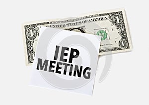 dollar with white card and text iep meeting