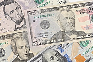 5, 20, 50, 100 dollars banknotes at different angles. Close up of dollars on white background.