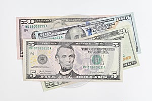 5, 20, 50, 100 dollars banknotes at different angles. Close up of dollars on white background.