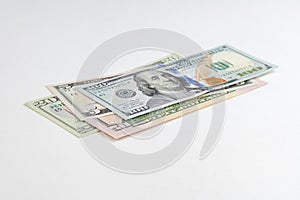 5, 20, 50, 100 dollars banknotes at different angles. Close up of dollars on white background.