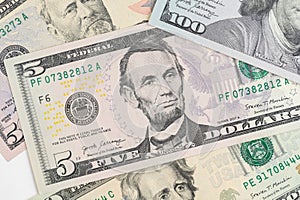 5, 20, 50, 100 dollars banknotes at different angles. Close up of dollars on white background.