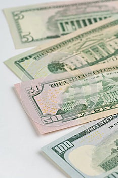 5, 20, 50, 100 dollars banknotes at different angles. Close up of dollars on white background.