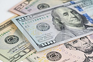 5, 20, 50, 100 dollars banknotes at different angles. Close up of dollars on white background.