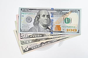 5, 20, 50, 100 dollars banknotes at different angles. Close up of dollars on white background.