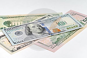 5, 20, 50, 100 dollars banknotes at different angles. Close up of dollars on white background.