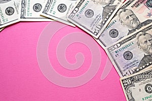 Dollars banknotes on pink background. Woman cost. Copy space for text. Exchange rates in bank