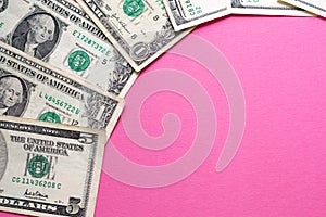 Dollars banknotes on pink background. Woman cost. Copy space for text. Exchange rates in bank