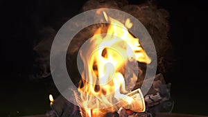 dollars are burning in a campfire burns US dollars banknotes on fire. Black background, isolate. The concept of