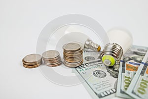 Dollars cents and two energy saving light bulbs