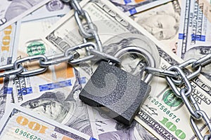 Dollars currency with lock and chain. Padlock with chain on the dollar bills. Business concept
