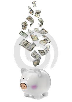 Dollars falling into piggy bank on background