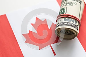 Dollars on flag of Canada, Canadian finance, subsidies, social support, GDP concept