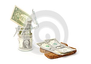 Dollars in a jar and on a slice of bread