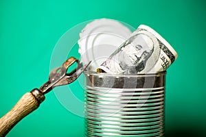 Dollars in an open tin can and a snippet. Safeguarding cash, stash concept. Time to get the deferred, accumulated money. Green