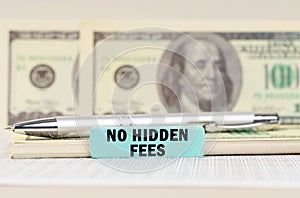 On the dollars are a pen and a sign with the inscription - No hidden fees