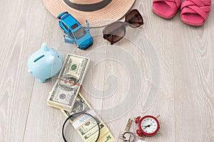 dollars, piggy bank, alarm clock, hat, glasses. Time to go on holiday. Things for summer trip.