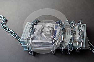Dollars tied up with a chain