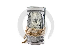 Dollars twisted into a roll isolated on white background.